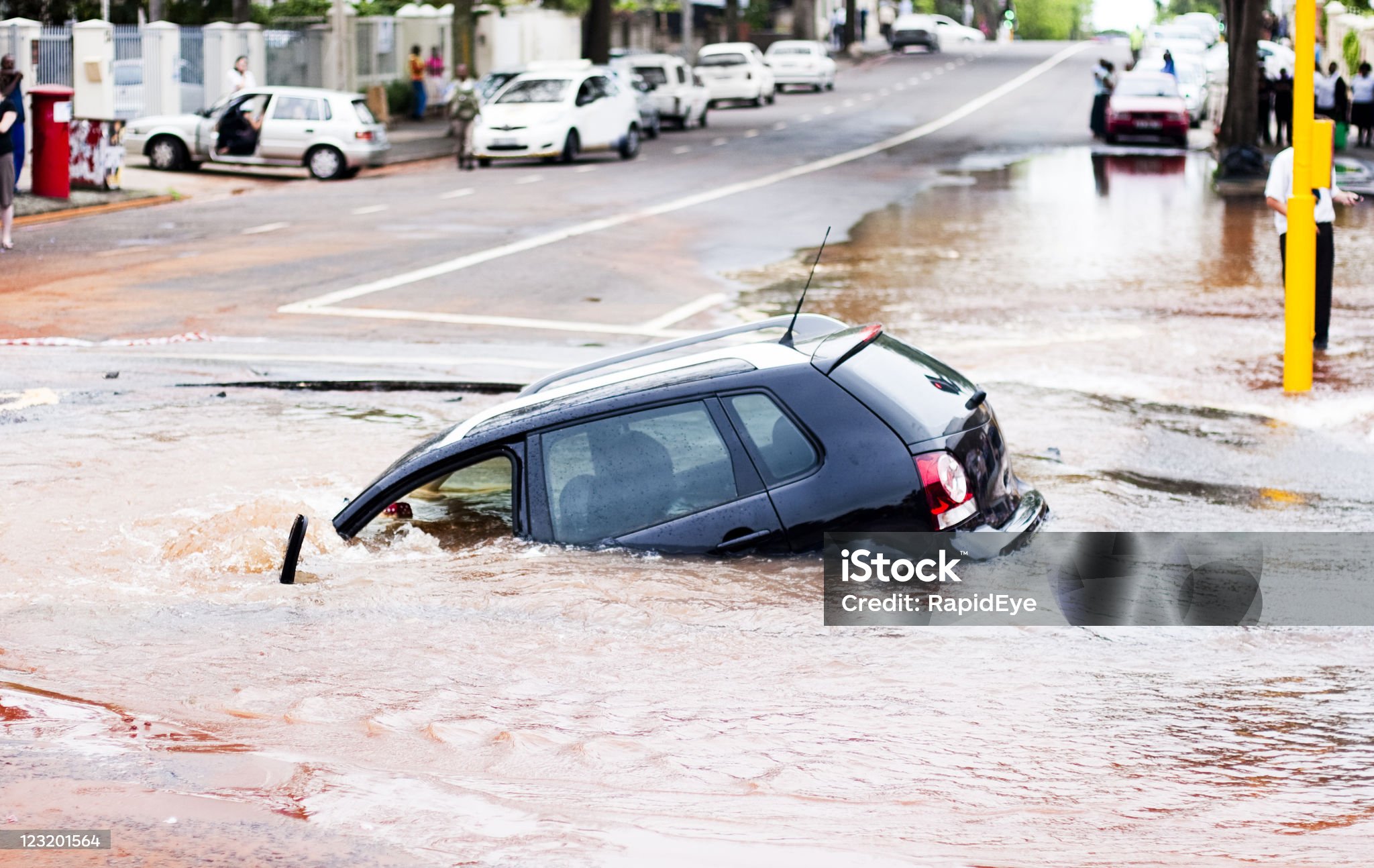 car-tips-into-pothole-in-flooded-street-side-view.jpg