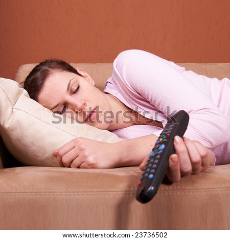stock-photo-a-young-woman-sleeping-on-a-sofa-in-front-of-a-tv-with-the-remote-control-slipping-out-of-her-hand-23736502.jpg